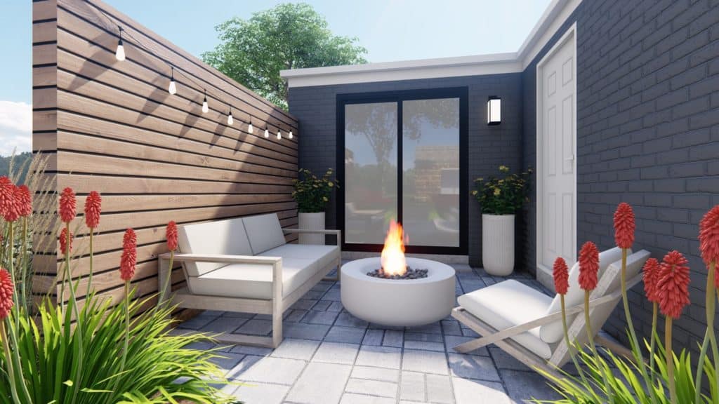 small paver patio in a backyard with round fire pit and modern coastal lounge furniture