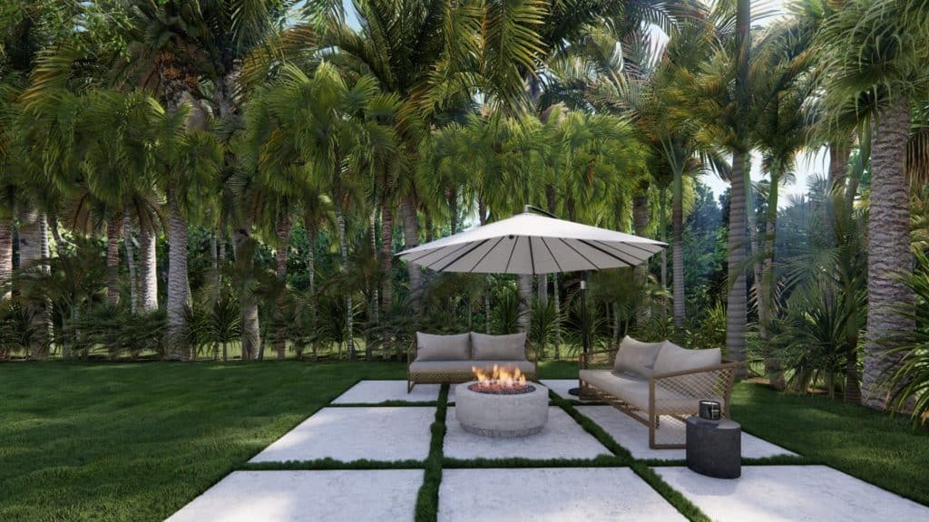 Yountville fire table in corner of tropical-style yard with two outdoor sofas and overhead cantilever umbrella